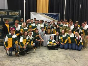 Clarkson University Pep Band standing around the 2017 D1 Women's Hockey National Championship Trophy