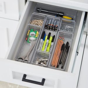 A desk with compartments that include office supplies of tape, penciles,scisors 