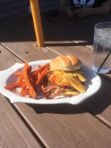 A sandwich and sweet potato fries from The Ole Smokehouse.