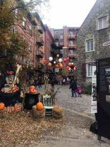 A walkable street decorated with pumpkins and Halloween decorations near Maison Historique Chevalier in Quebec City.