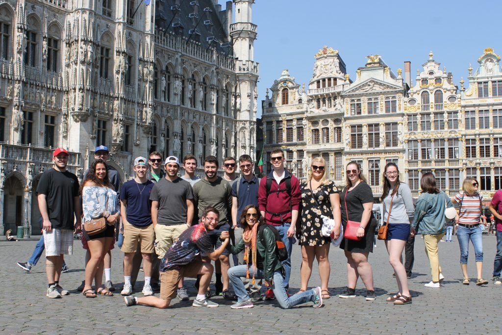 A group of students pose in front of the Grand Place in Brussels. 