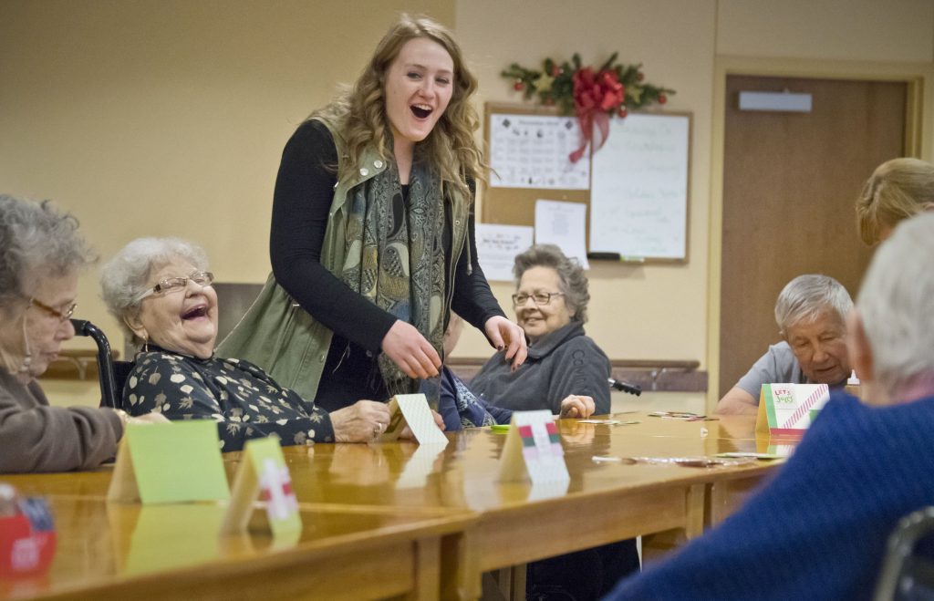 Rebecca Brogan, shares a laugh with residents while helping run a table activity