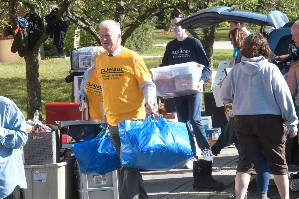 Former Clarkson President Tony Collins helps new students and families move in to their residence halls during move in weekend. 