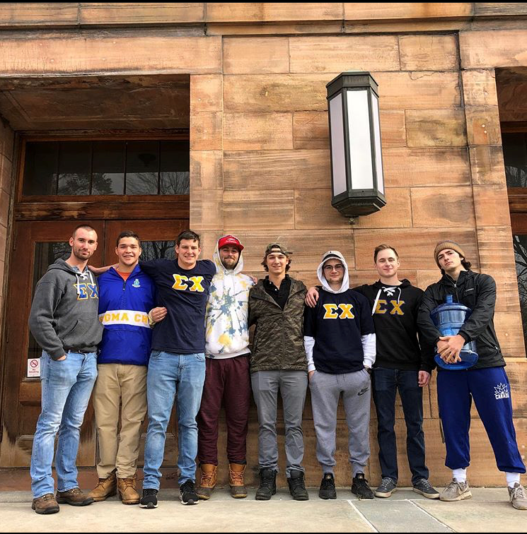 Eight Sigma Chi brothers in front of Old Main