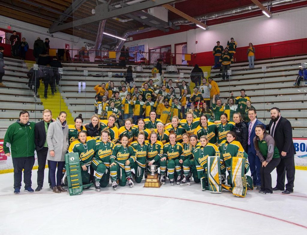 The Clarkson Pep Band poses with the women's ice hockey team to celebrate their National Championship victory.