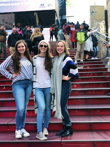 Jackie and friends standing on the TKTS booth/Red Steps in NYC