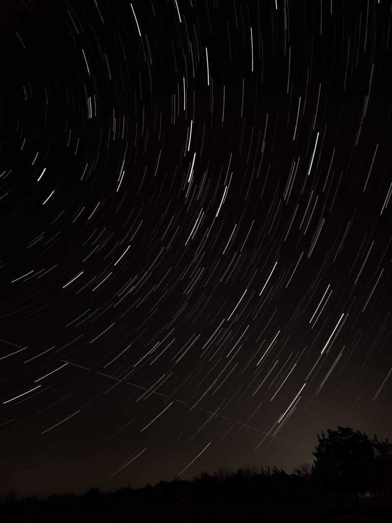 star trails rotating around a point just off screen to the left