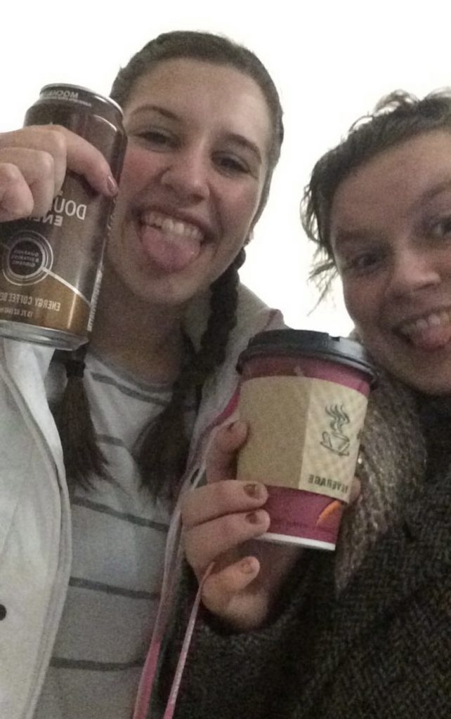 Megan and her roommate holding coffees during finals week