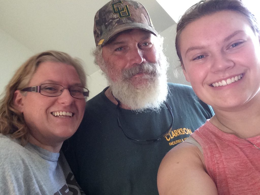 Megan and her parents on move-in day in 2016