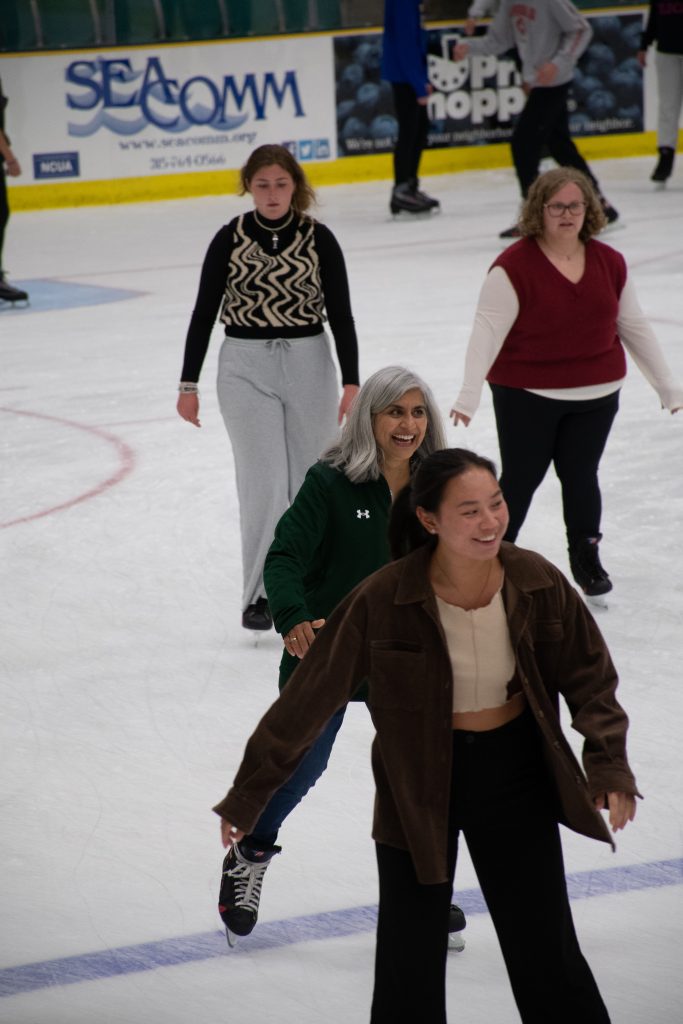 Four women skate on the ice surface at Cheel Arena. 
