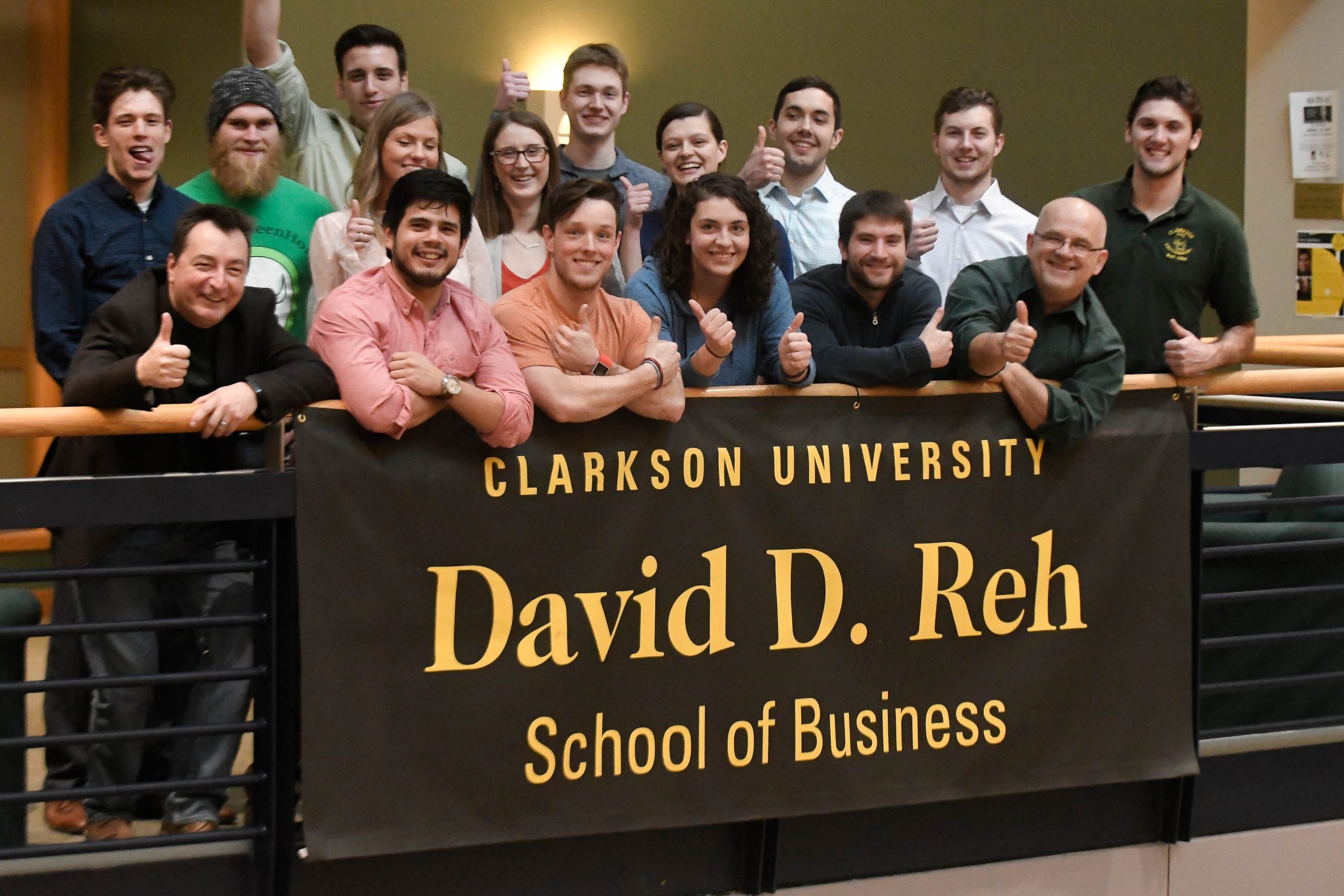 A large group of people standing behind the David D. Reh sign