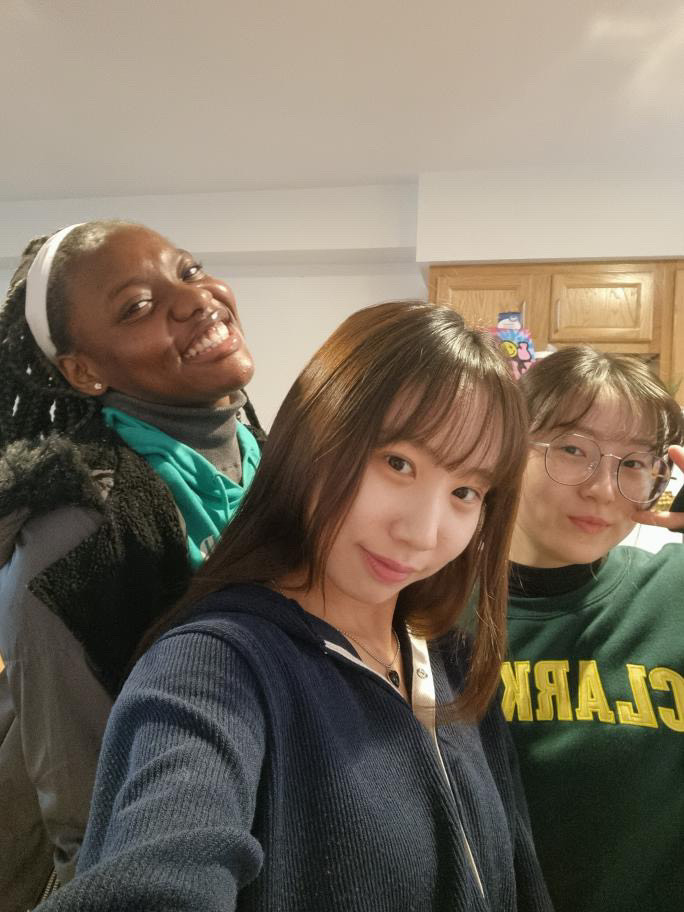 Chidi is pictured in university housing apartments smiling with friends 