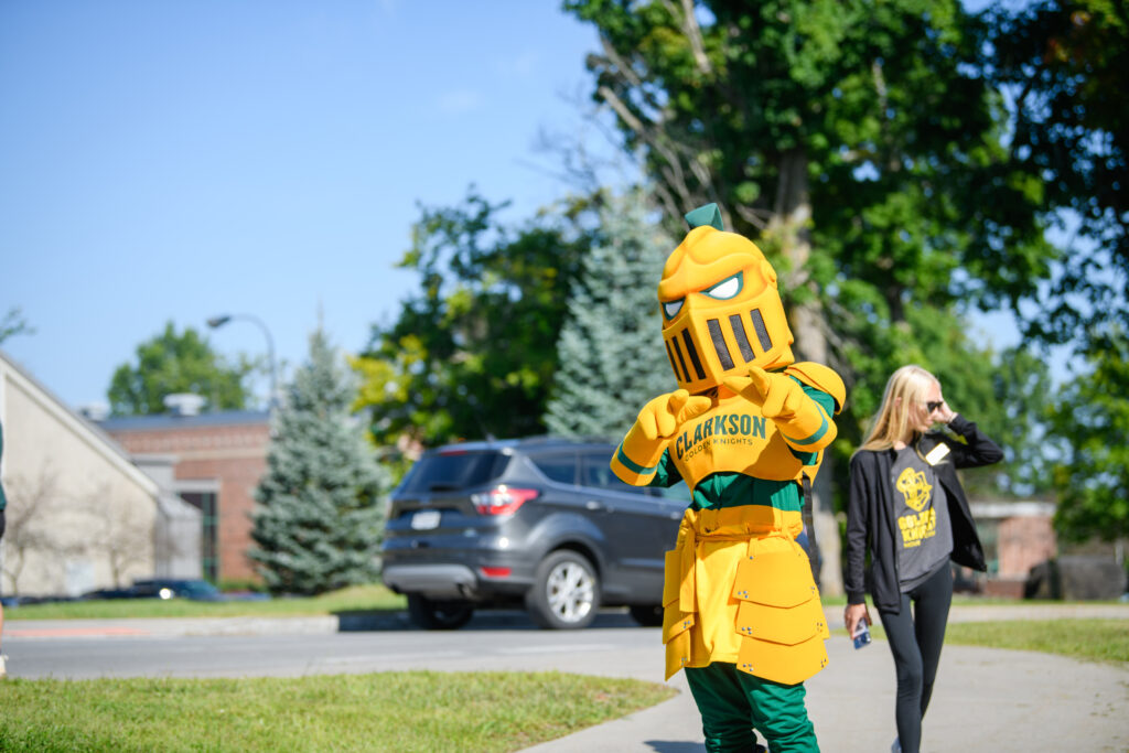 The Clarkson mascot, the Golden Knight, points at the camera on the Potsdam Campus 