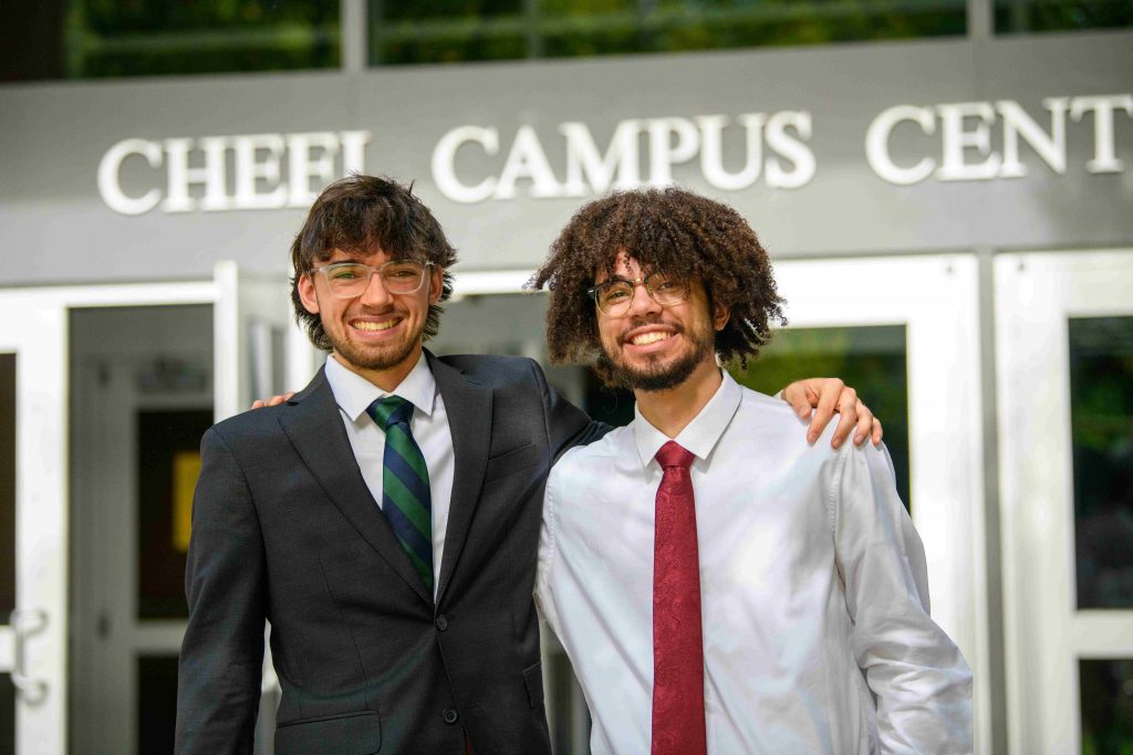 Two Clarkson students dressed in business attire outside Cheel Campus Center during the career fair.