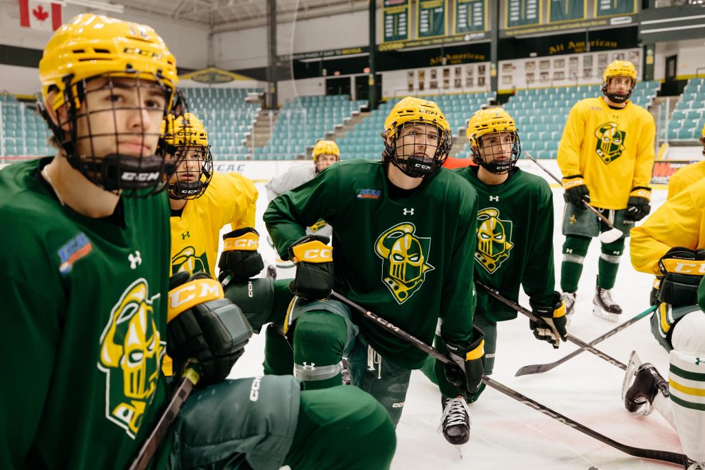 Clarkson University men's hockey team on the ice during practice, highlighting student-athlete involvement alongside Business Administration studies.