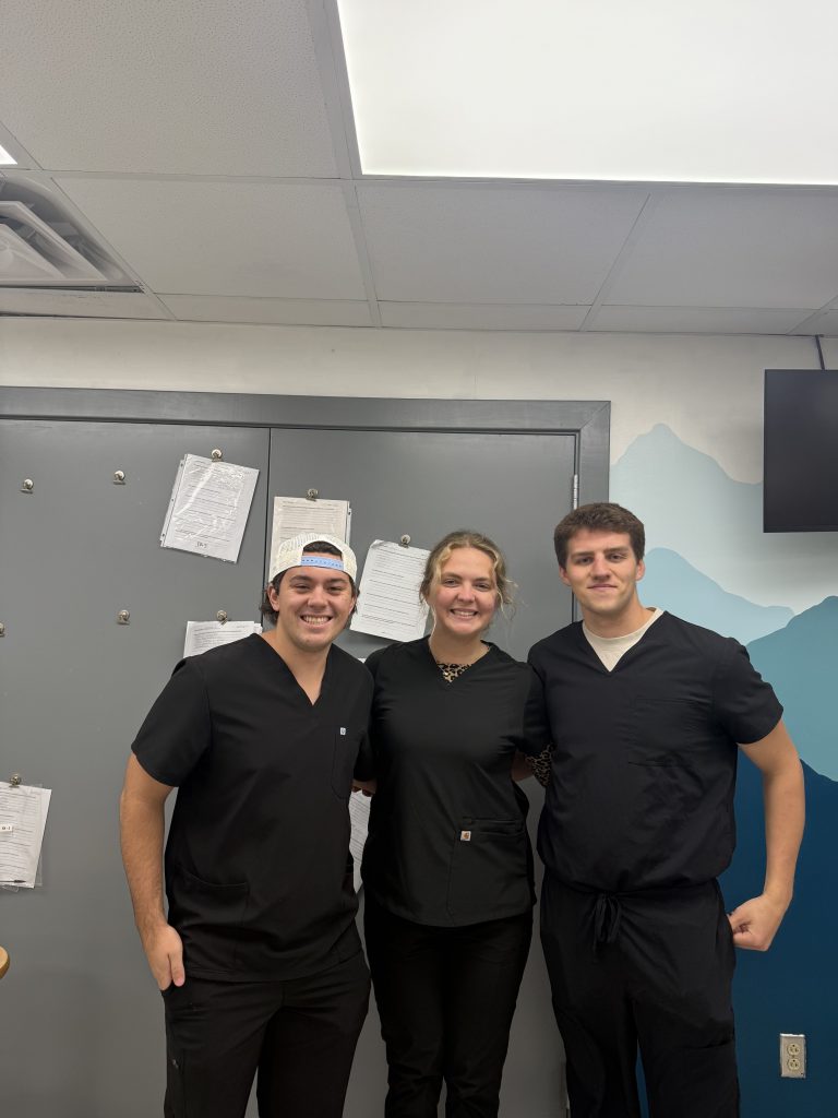 Three Clarkson students standing next to each other facing the camera