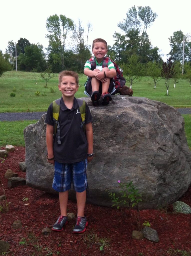 Miles and Owen Compani smile together at a young age.
