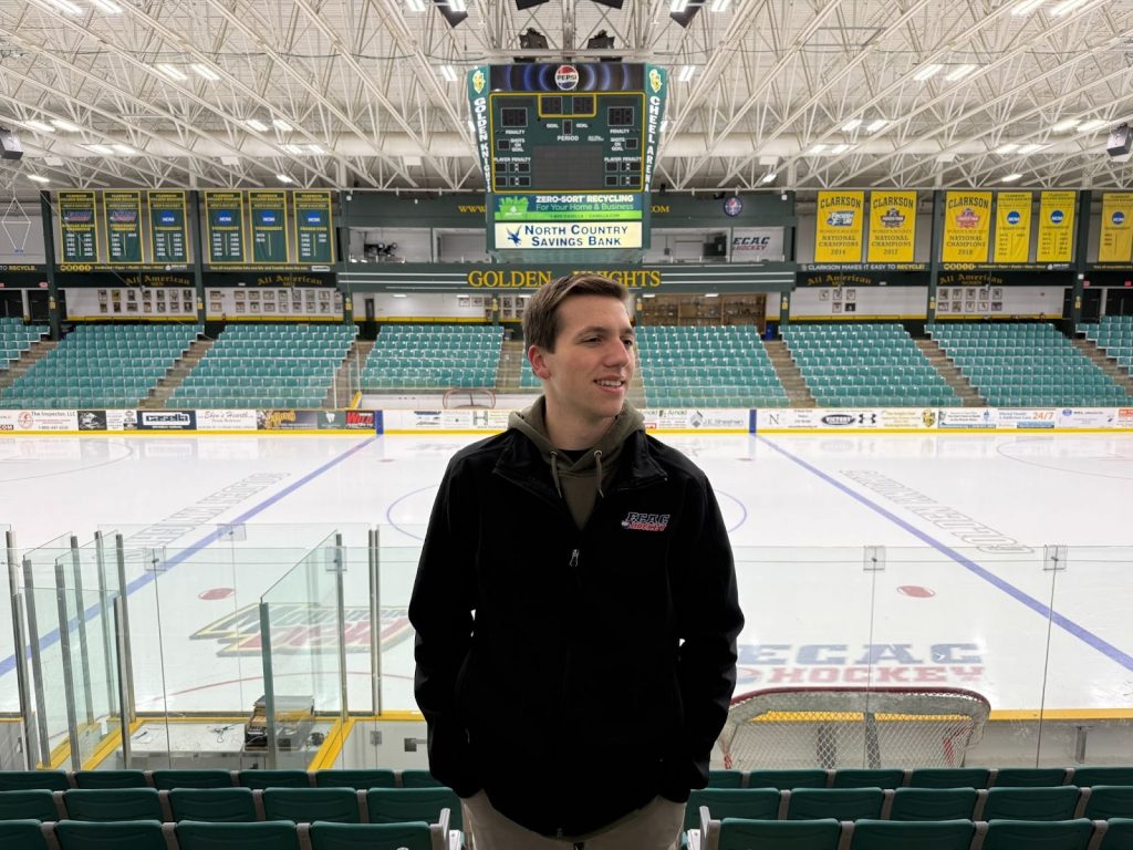 A male student stands in front of Cheel Arena.
