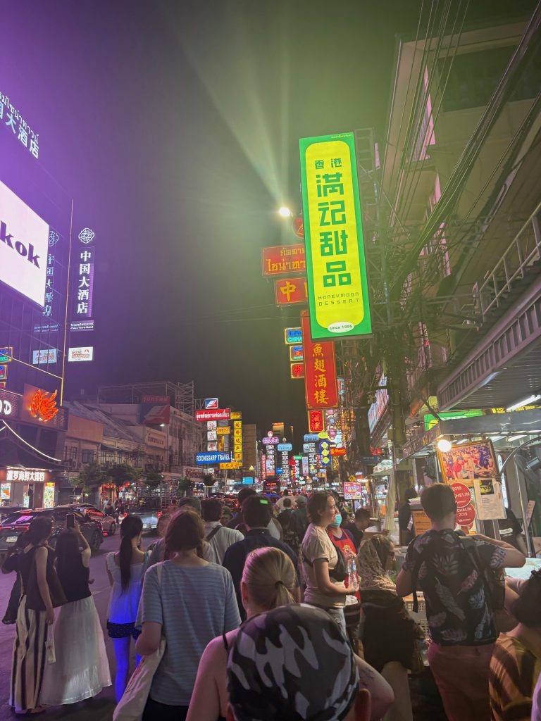 Studnets walking through Chinatown In Bangkok, Thailand.