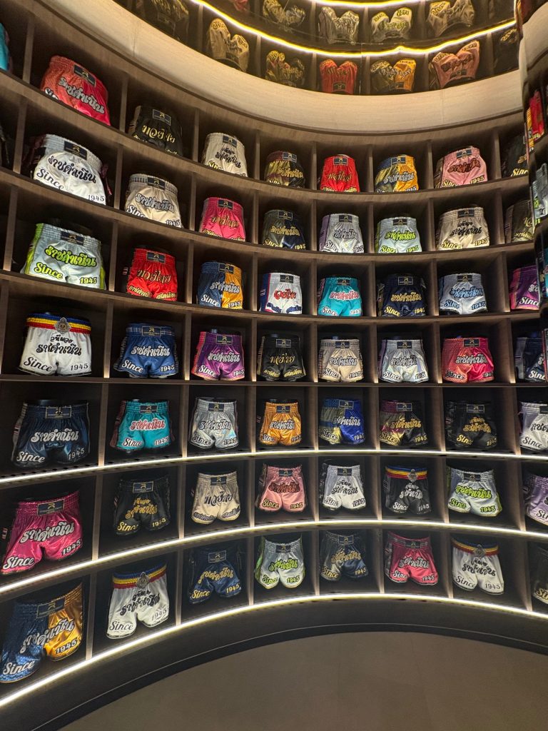 A wall of Muay Thai boxing shorts.